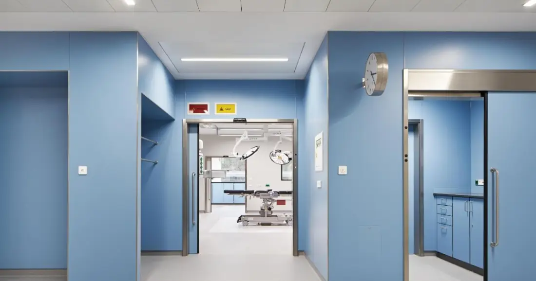 Operating theatre corridor lined with blue modular wall panels
